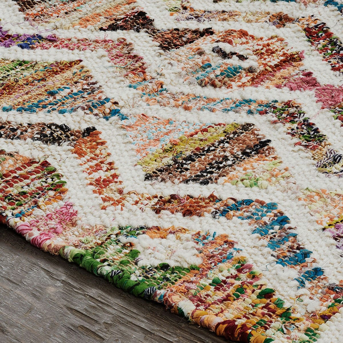 5' X 8' Ivory Blue Pink Gold And Green Geometric Hand Woven Area Rug With Fringe