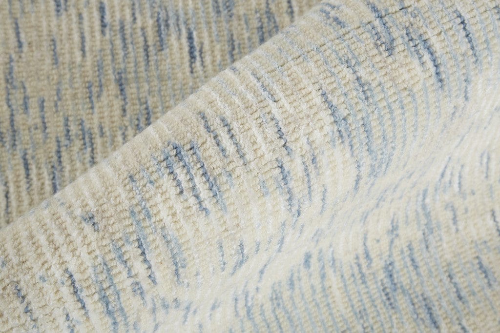 5' X 8' Ivory And Tan Abstract Hand Woven Area Rug