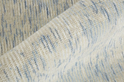 5' X 8' Ivory And Tan Abstract Hand Woven Area Rug