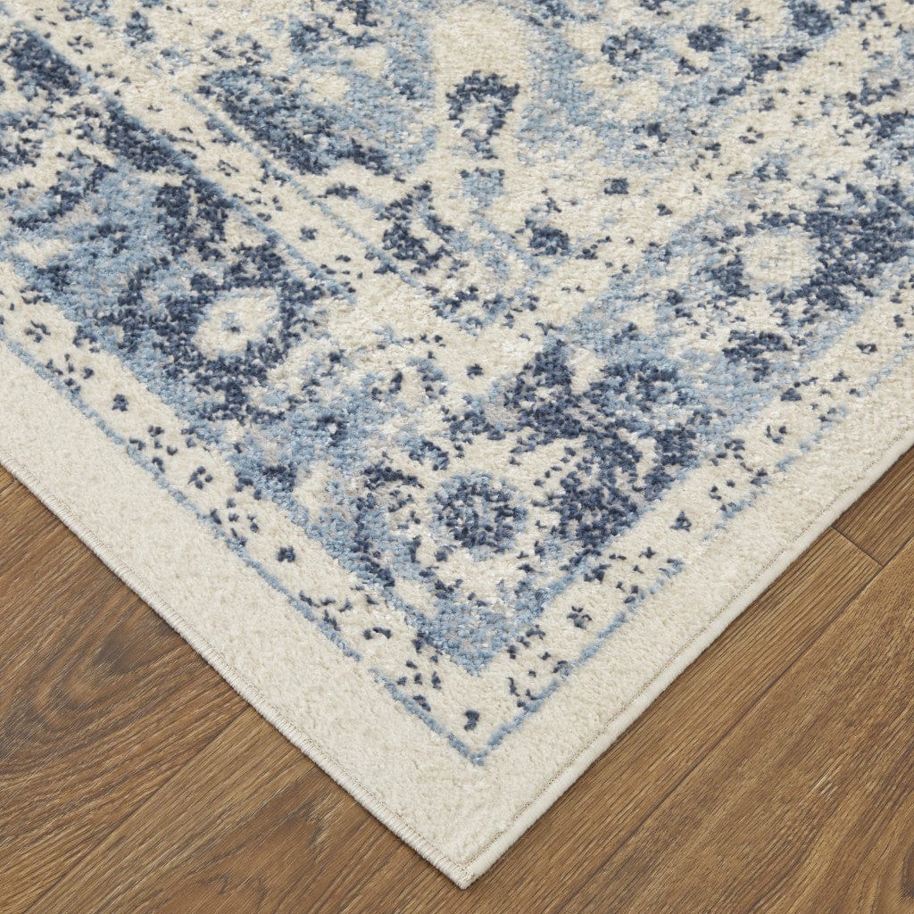 5' X 8' Ivory And Blue Floral Power Loom Distressed Area Rug