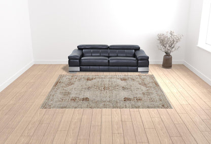 8' X 10' Tan Ivory And Orange Floral Power Loom Distressed Area Rug With Fringe