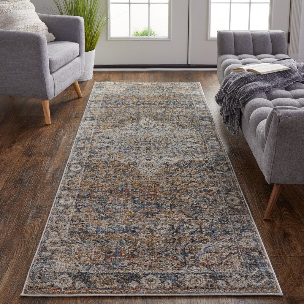 5' X 8' Tan Orange And Blue Floral Power Loom Distressed Area Rug With Fringe
