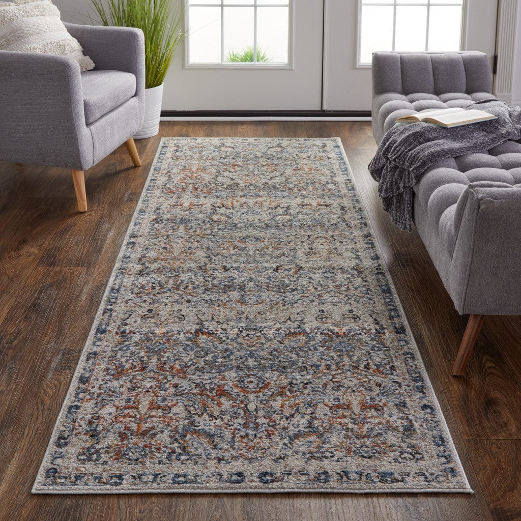 5' X 8' Tan Blue And Orange Floral Power Loom Distressed Area Rug With Fringe