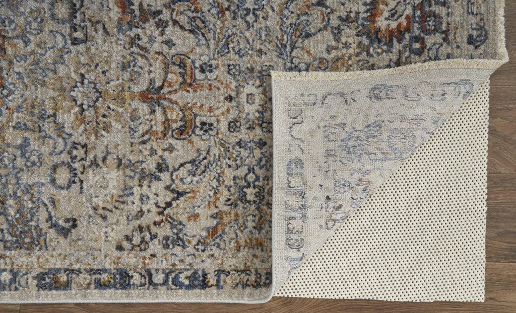 5' X 8' Tan Blue And Orange Floral Power Loom Distressed Area Rug With Fringe